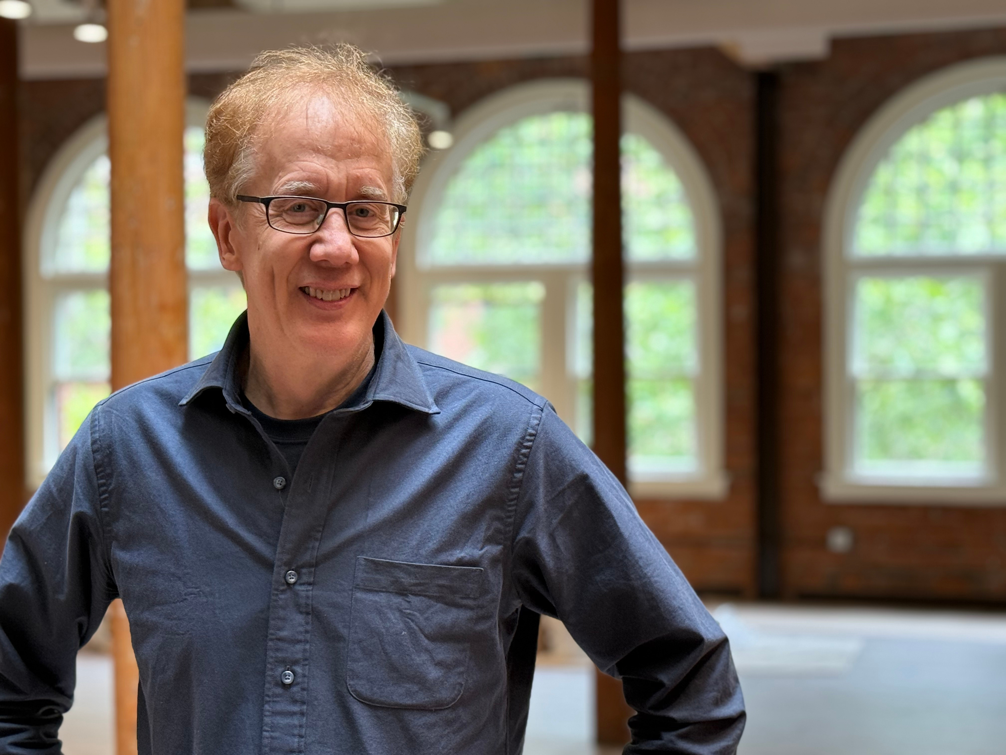 Andrew Conru in the atelier space with natural lighting